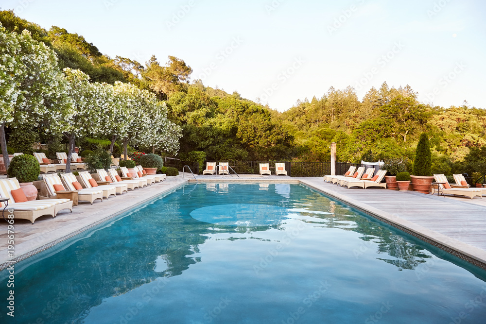 Pool and loungers at luxury resort and spa Pool and loungers at luxury resort and spa