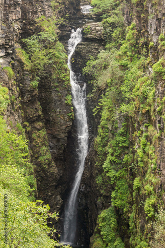 Braemore, Scotland - June 8, 2012: Closeup of waterfall of Corrieshalloch Gorge, a deep cut in landscape with forested vertical slopes.