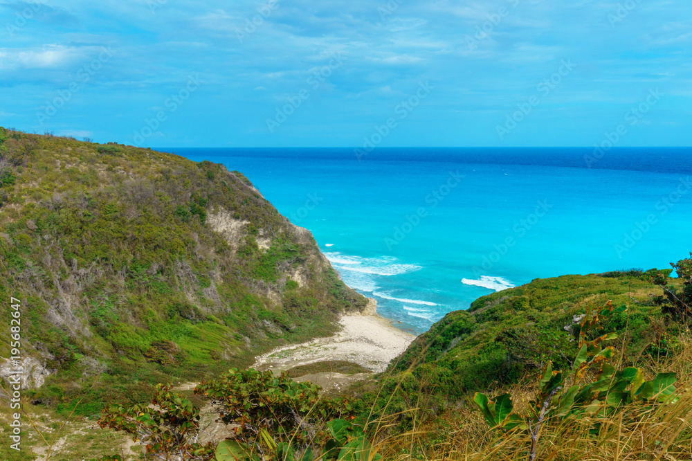 hidden picturesque Caribbean Bay, azure sea and green cliffs hidden picturesque Caribbean Bay, azure sea and green cliffs