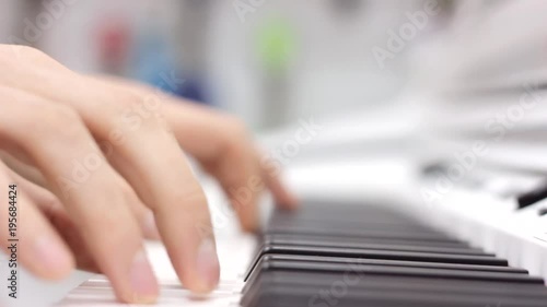 Close-up of a music performer's hand playing the piano