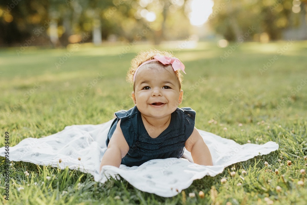 Baby Smiling on a Blanket at the Park Baby Smiling on a Blanket at the Park