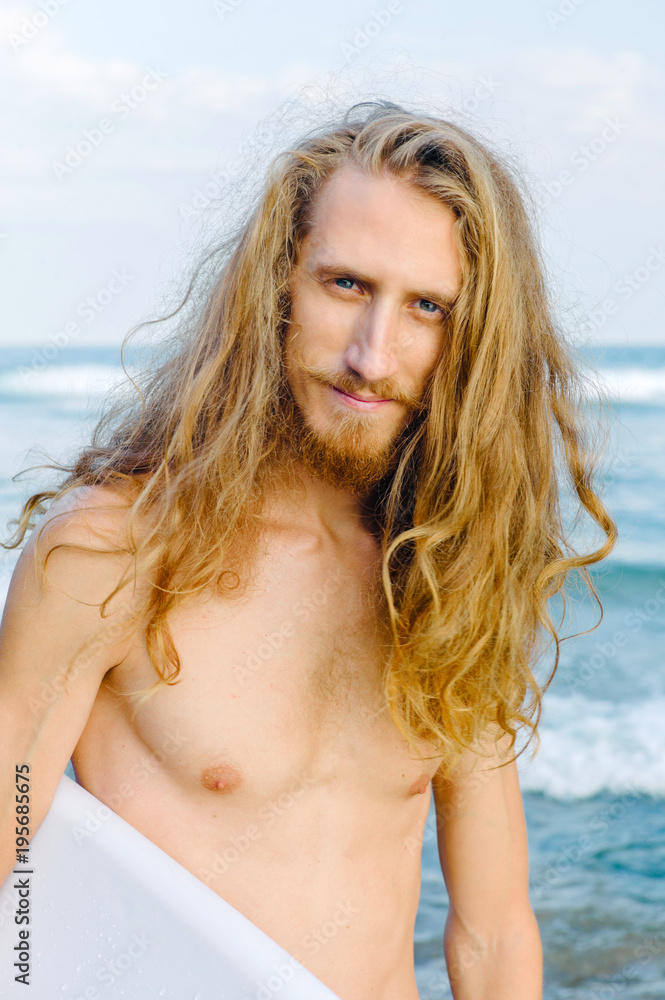 Male surfer looking at camera Male surfer looking at camera