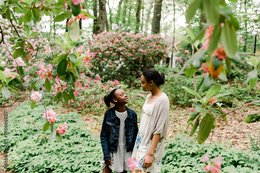 two african american sisters in a garden two african american sisters in a garden