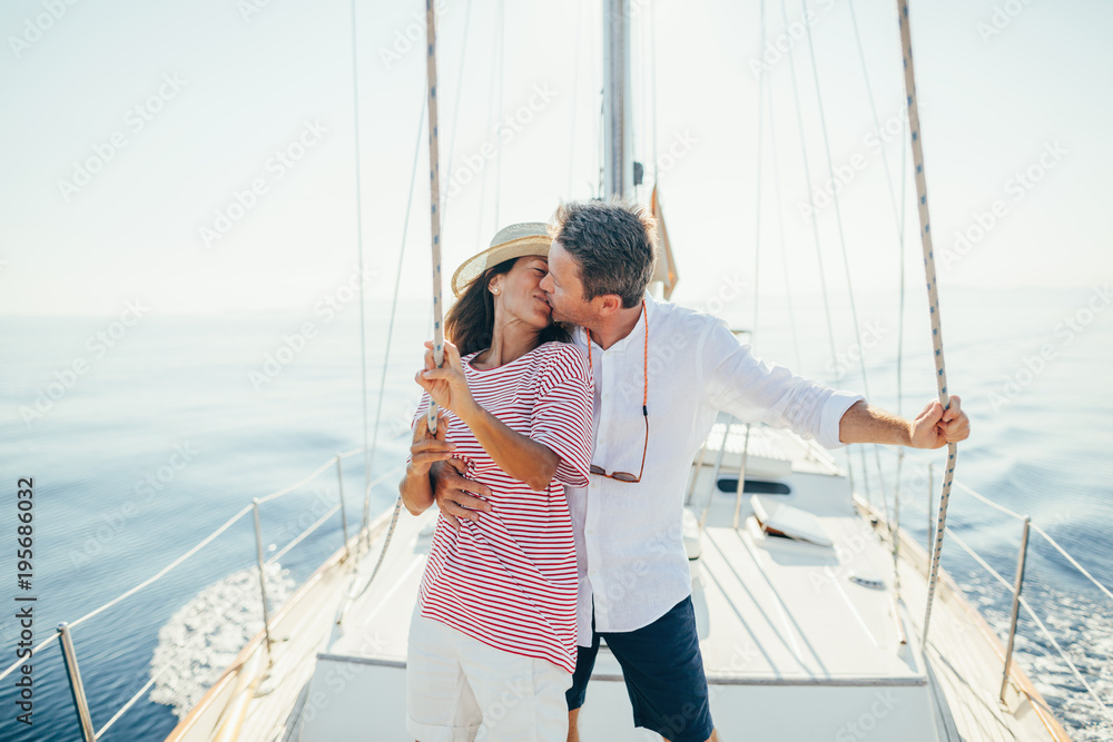 Kissing lovely couple on sailboat. Kissing lovely couple on sailboat.