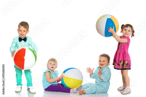 Cheerful children play with a ball.