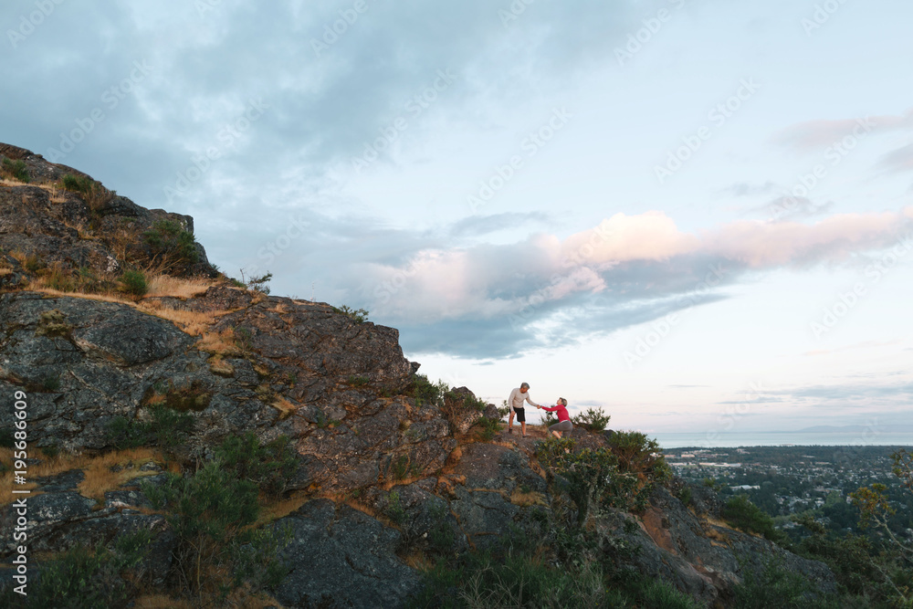 Fit, active middle age couple hiking together at sunset Fit, active middle age couple hiking together at sunset