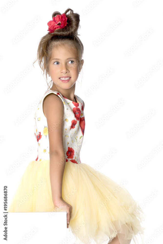 A little girl is looking from behind an empty banner. A little girl is looking from behind an empty banner.