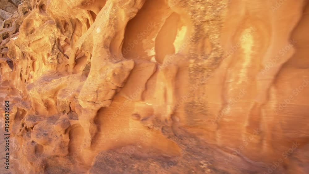 Hiking along desert canyon wall viewing grooves and texture in Crack Canyon. Hiking along desert canyon wall viewing grooves and texture in Crack Canyon.