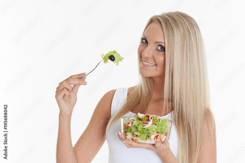 Slender woman holds a bowl of salad. Slender woman holds a bowl of salad.