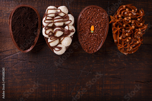 Chocolate egg with filling for Easter on wooden background