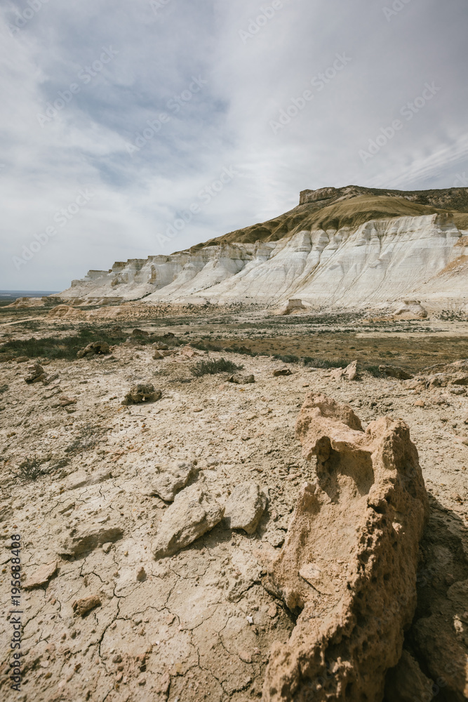 dried earth and white rugged mountains in kazakh steppe dried earth and white rugged mountains in kazakh steppe