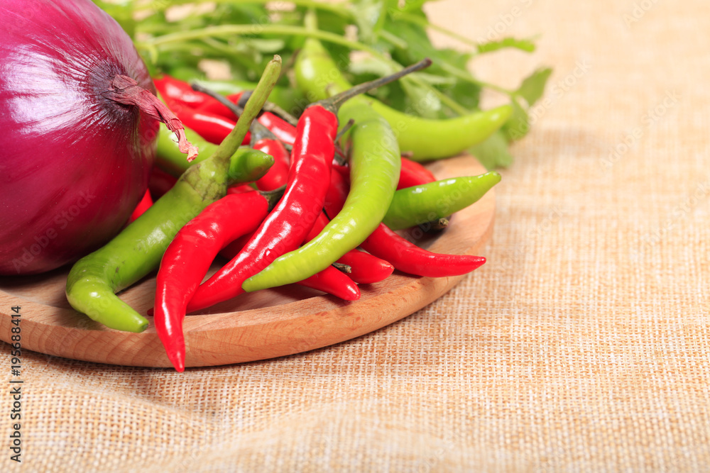 Red pepper, green chilli, peppercorns and onion, food background