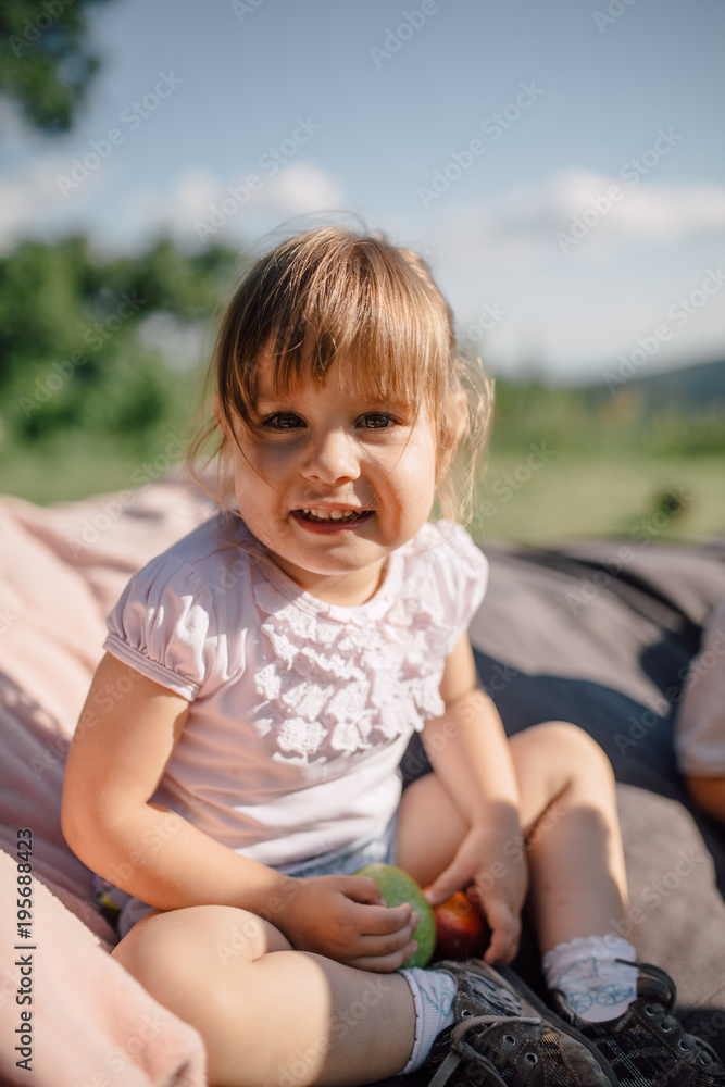 Adorable little girl eating an apple Adorable little girl eating an apple