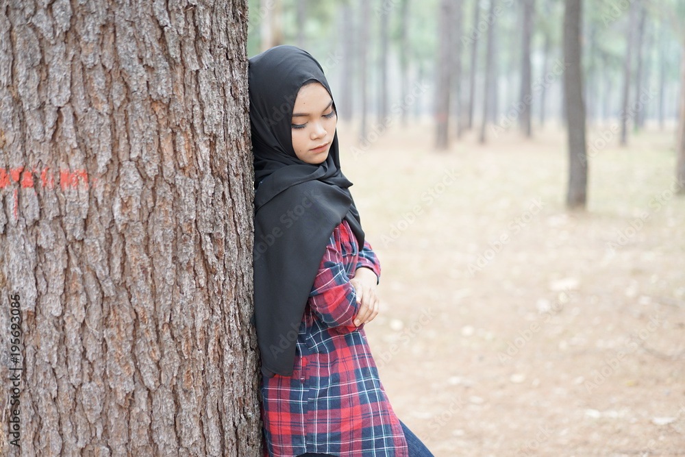 Portrait of happy young muslim woman black hijab and Scottish shirt in autumn season background. Portrait of happy young muslim woman black hijab and Scottish shirt in autumn season background.