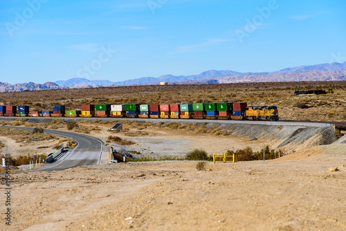 Union Pacific railroad locomotive carrying long freight cars