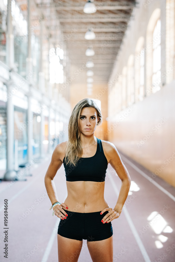 Confident woman posing in gym Confident woman posing in gym