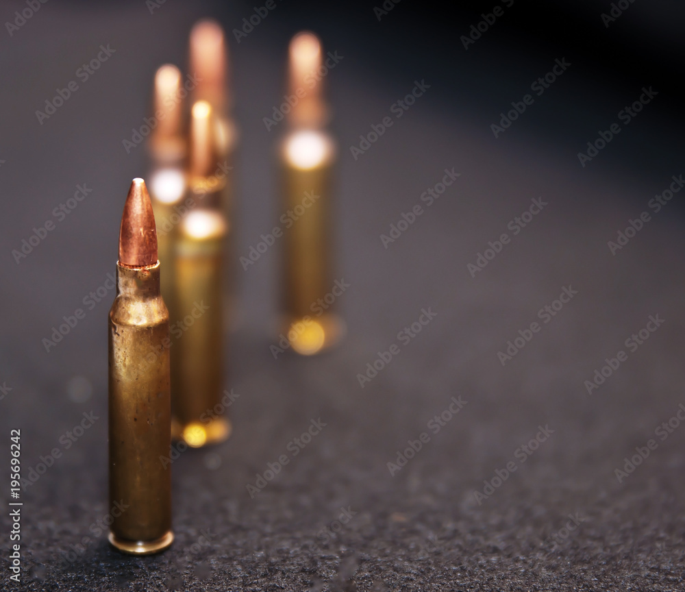 Five .223 caliber rounds on a black background with room for the text on the right side Five .223 caliber rounds on a black background with room for the text on the right side