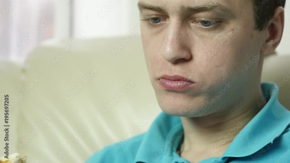 skinny man eats fast food snack with great enjoyment. guy chewing junk food with big appetite. slow motion skinny man eats fast food snack with great enjoyment. guy chewing junk food with big appetite. slow motion