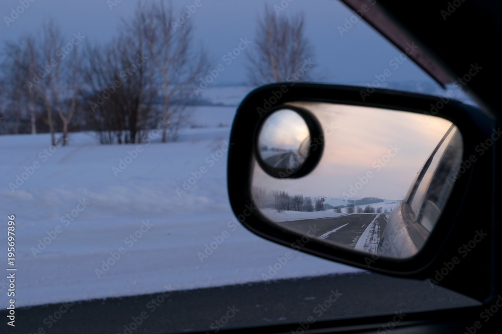 reflection in rear view mirror of night road, hills and sunset reflection in rear view mirror of night road, hills and sunset