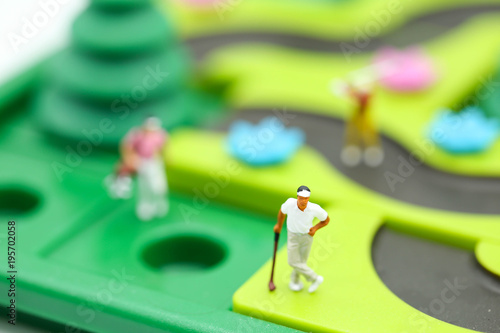 Miniature people : golfer stand with children's toys collection,sport and education concept.