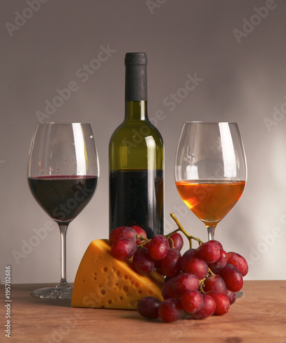 still life with glass and bottle of wine  cheese and grapes