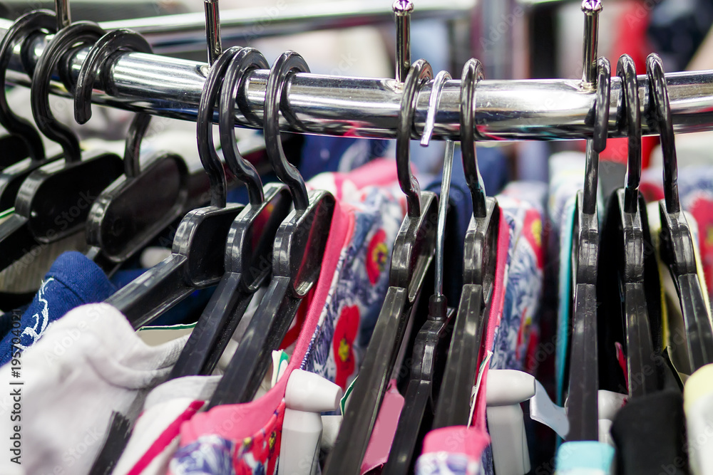 Hangers with clothes in a fashionable clothing boutique close-up. Shopping clothing concept. Things on the hangers in the store. Hangers with clothes in a fashionable clothing boutique close-up. Shopping clothing concept. Things on the hangers in the store.