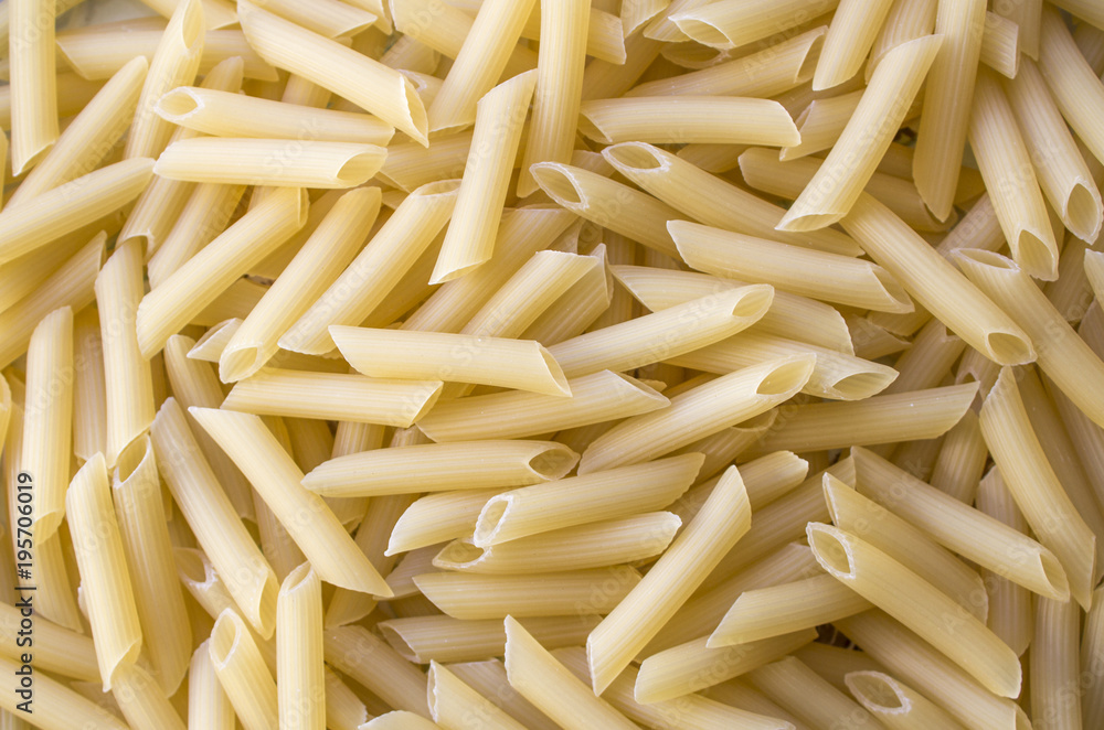Dry pasta background, healthy food, yellow background Dry pasta background, healthy food, yellow background
