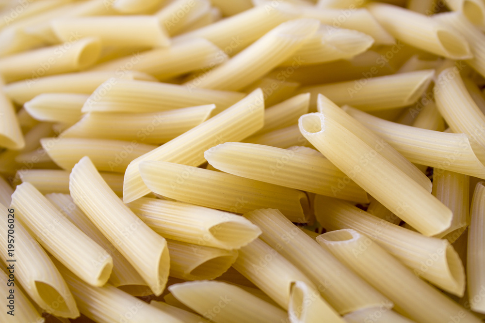 Dry pasta background, healthy food, yellow background Dry pasta background, healthy food, yellow background