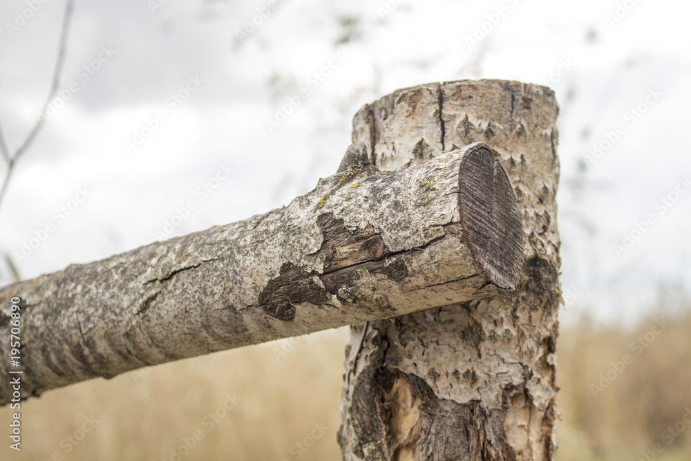Fototapeta premium Wooden fence near the river. connection of beams