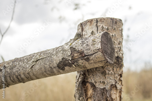 Wooden fence near the river. connection of beams
