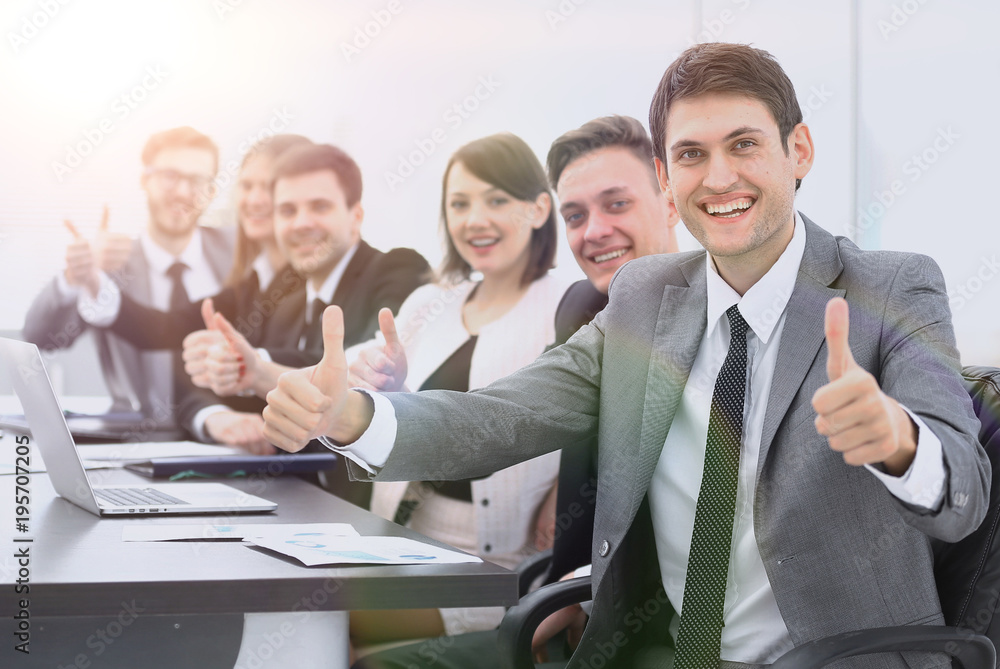 successful business team showing thumbs up successful business team showing thumbs up