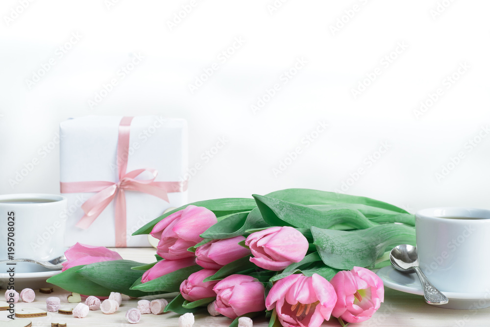 Soft romantic composition. Tulips, gifts, two cups of coffee and tender stuff Soft romantic composition. Tulips, gifts, two cups of coffee and tender stuff