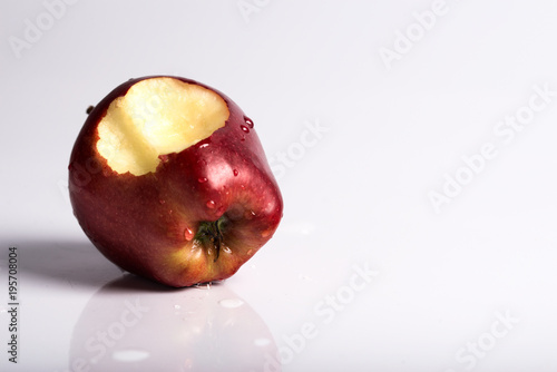 A bitten red apple, on a white background.