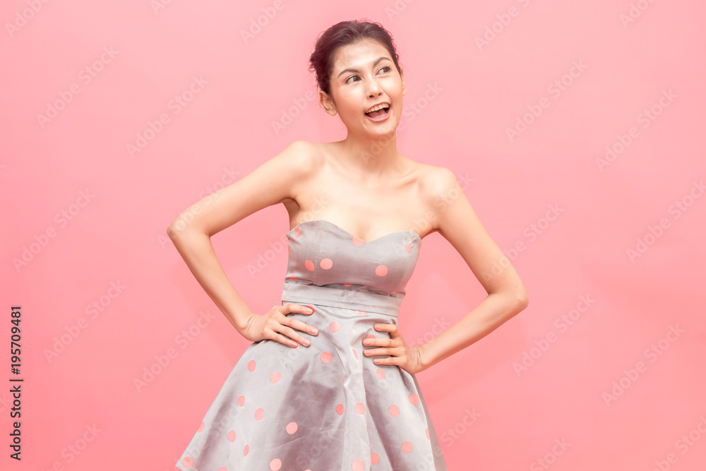 Portrait of fashion smilling young beautiful woman model posing on pink background