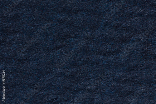 Dark blue crumpled paper background.