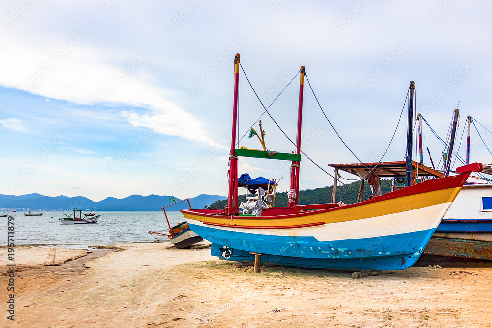 Colorful wooden fishing boat at the beach in Porto Belo.