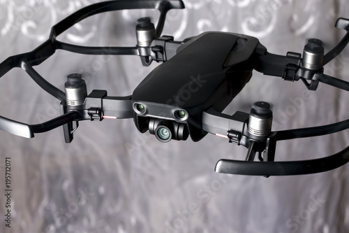 quadroopter flies in the room, with protective accessories on it