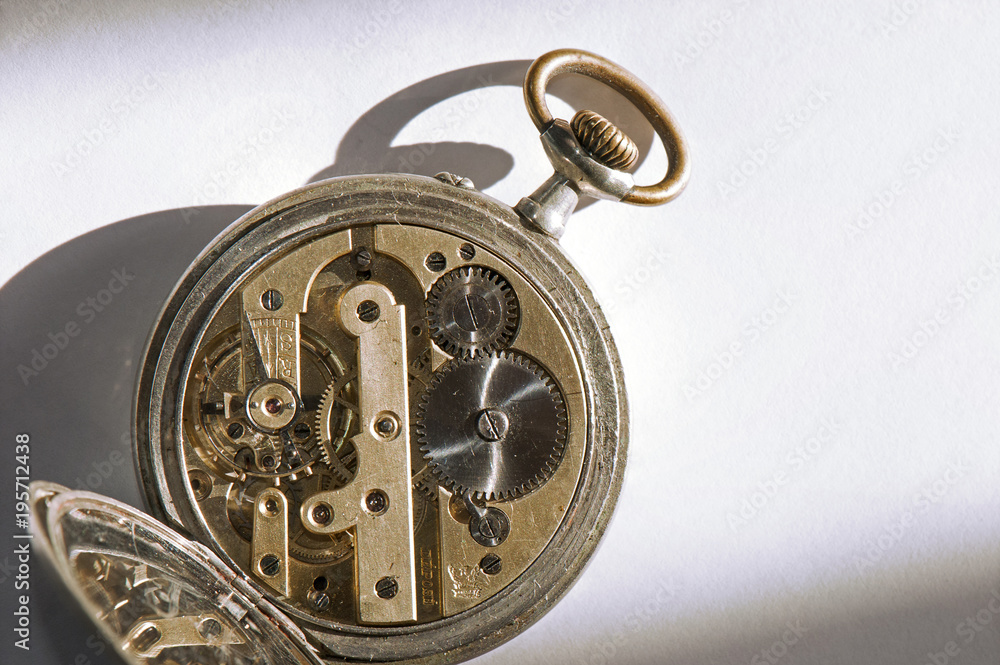 Vintage pocket watch with back open, showing clockwork