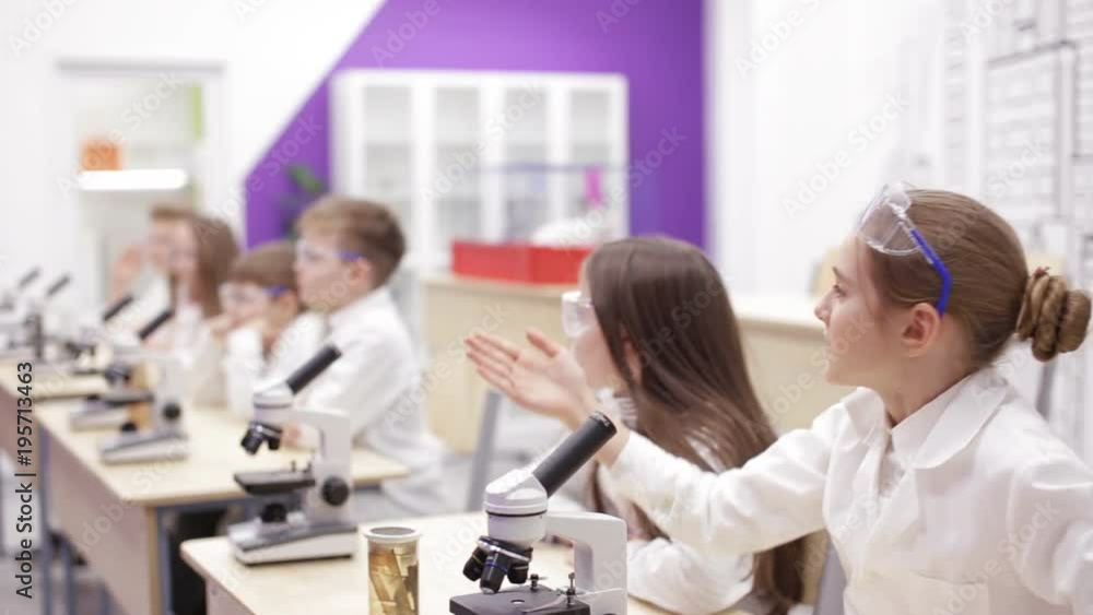Children at school looking into microscope Children at school looking into microscope