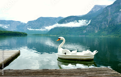 lake Hallstatt with  white Swan boat and Wooden pier