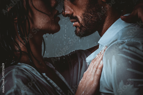 Couple sharing romantic moments under the rain photo