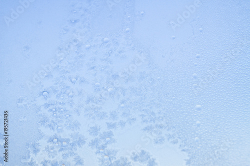 Winter frosty patterns on the frozen ice window