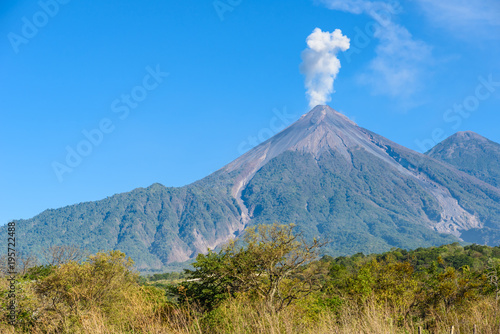 Amazing volcano El Fuego during a eruption on the left and the Acatenango volcano on the right, view from Antigua, Guatemala