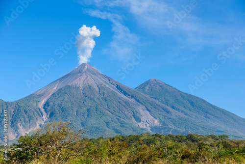 Amazing volcano El Fuego during a eruption on the left and the Acatenango volcano on the right, view from Antigua, Guatemala