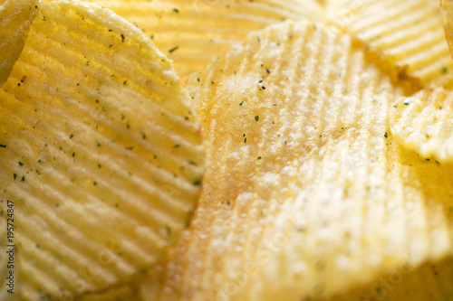 Closeup of ridged potato chips, crisps. Texture and background