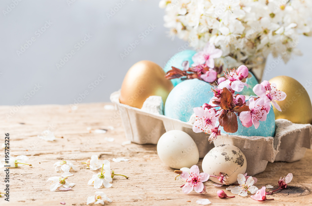 Fototapeta premium Easter holiday background, greeting card.Easter colored eggs and spring flowers on rustic wooden table background copy space.