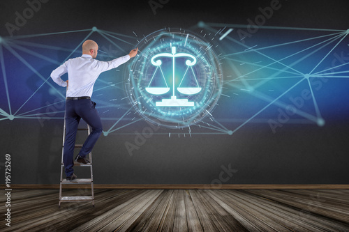 Businessman in front of a wall with justice balance icon on a futuristic interface