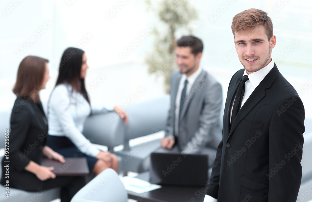 portrait of confident businessman on background of office. portrait of confident businessman on background of office.