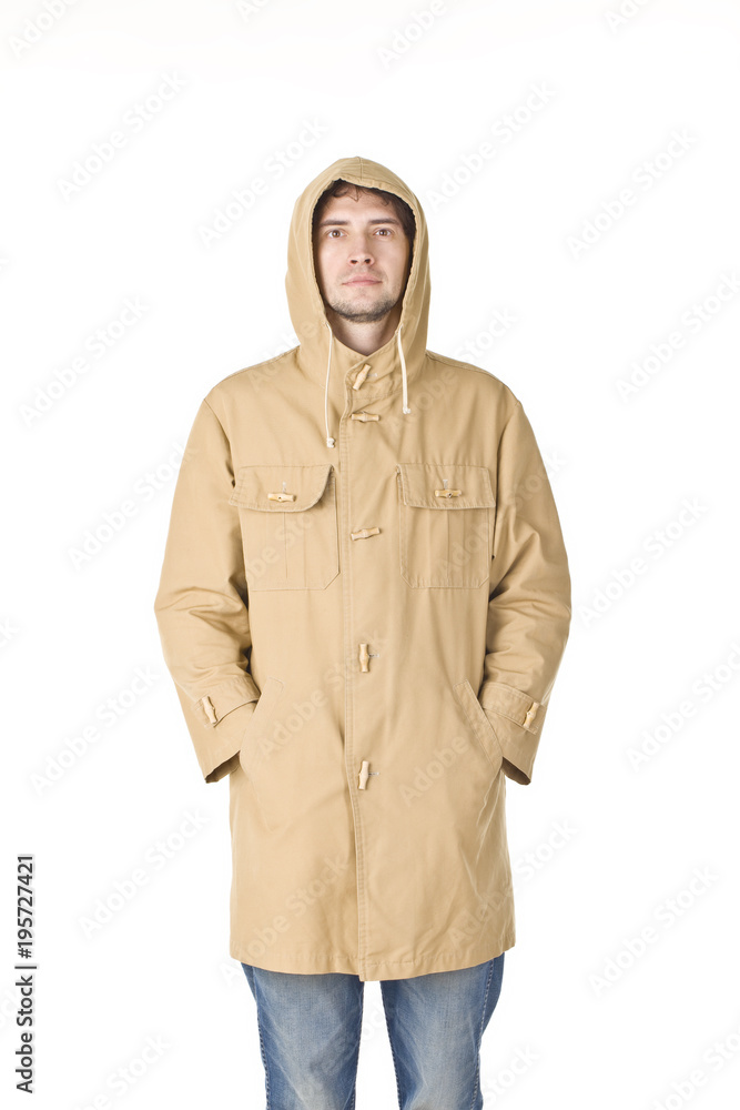 Man standing in raincoat and keeping his hands in pockets Man standing in raincoat and keeping his hands in pockets