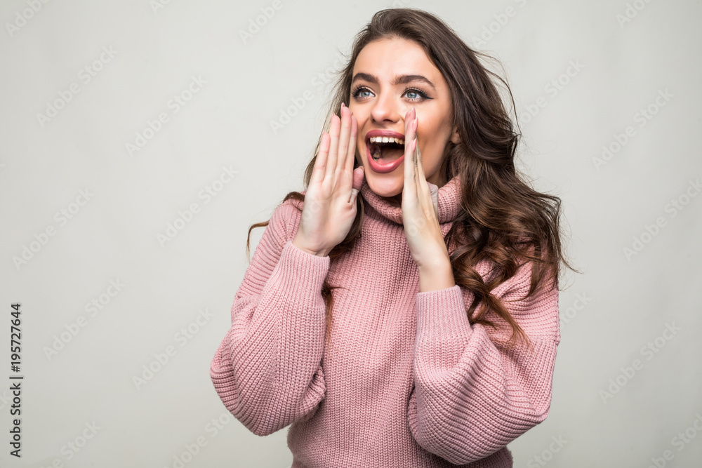 Young beauty woman shout and scream using her hands as tube, studio shoot isolated on white background Young beauty woman shout and scream using her hands as tube, studio shoot isolated on white background